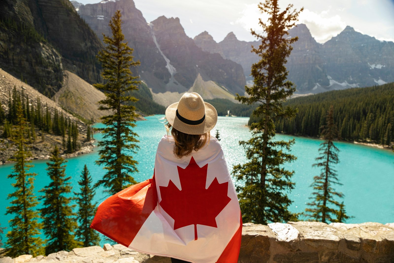 Canada immigration guide 2026 - person wrapped in a Canadian flag welcoming newcomers